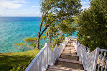 Fototapeta na wymiar A wooden staircase descends to the sea coast.Horizontally.