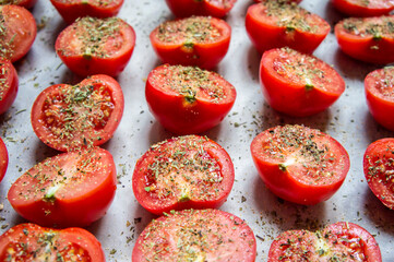 Fresh red tomatoes with spices close-up.