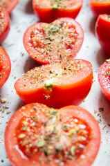 Fresh red tomatoes with spices close-up.
