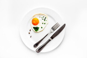 Fried eggs on plate - white kitchen table top view