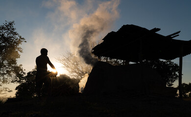 Smoke from antique charcoal kiln made from clay, used for burning charcoal from wood,air pollution...