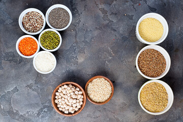 Superfoods and cereals selection in bowls on grey concrete background
