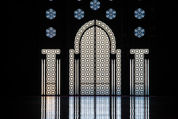 the daily life of different people at the Hassan II Mosque in Casablanca, the pray, talk, and spent time together on a normal summer day.  The mosque has unique and Arabic doors and towers
