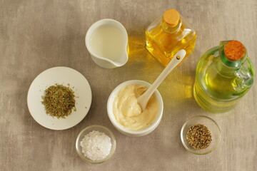 Ingredients for salad dressing with mayonnaise, vinegar, oil and spices