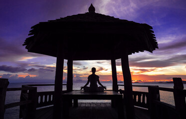 Serenity and yoga practicing by the sea sunset, meditation