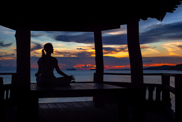 Serenity and yoga practicing by the sea sunset with island view, meditation