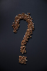 question mark with buckwheat On gray background, top view, copy space. Food supplies crisis, food donation on quarantine isolation period.