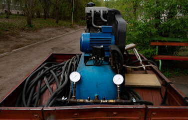 Large air compressor with a blue receiver.
