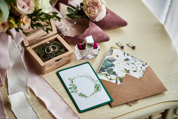 Fototapeta na wymiar bridal accessories such as shoes, bouquet , ring and parfume on a table