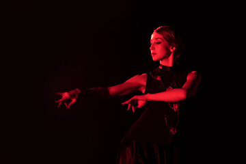 red lighting on beautiful woman dancing flamenco isolated on black
