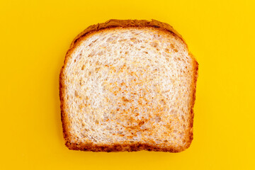 Close up photo of toasted bread on yellow background. Top view of roasted toast. Fried bread for breakfast.