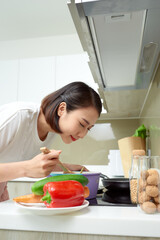 Young Woman Cooking in the kitchen. Healthy Food. Dieting Concept. Healthy Lifestyle. Cooking At Home. Prepare Food