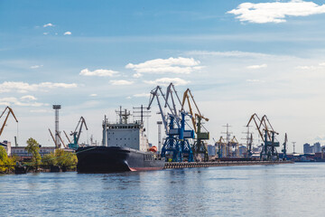 Fototapeta na wymiar cargo cranes in a river port