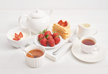 Strawberries and pancakes. Pancakes with strawberries. Romantic breakfast. Valentine's Day. Greeting Card Mother's Day. Breakfast in hotel room. Maslenitsa. Pancake week. Women's Day Congratulation