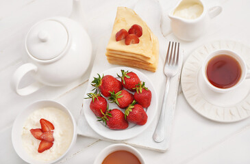 Strawberries and pancakes. Pancakes with strawberries. Romantic breakfast. Valentine's Day. Greeting Card Mother's Day. Breakfast in hotel room. Maslenitsa. Pancake week. Women's Day Congratulation