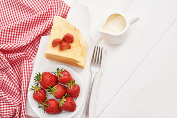 Strawberries and pancakes. Pancakes with strawberries. Romantic breakfast. Valentine's Day. Greeting Card Mother's Day. Breakfast in hotel room. Maslenitsa. Pancake week. Women's Day Congratulation