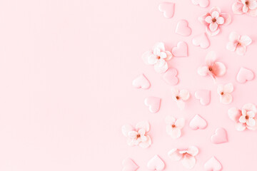 Flowers composition. Pink flowers hearts on pastel pink background. Flat lay, top view, copy space