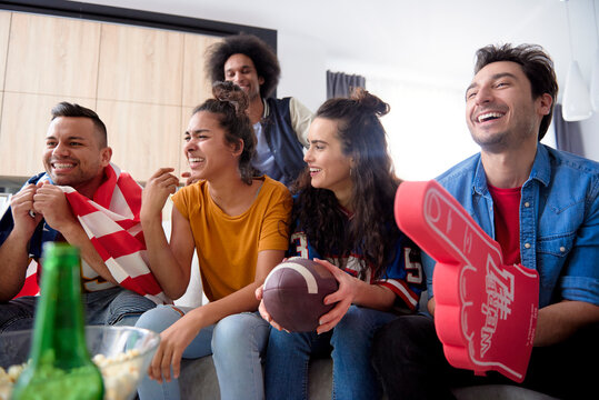 American football fans spending time in front of TV at home