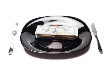 money on the plate with knife and fork