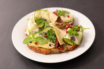 bread slice with zucchini, cheese, dry tomato and cheese cream