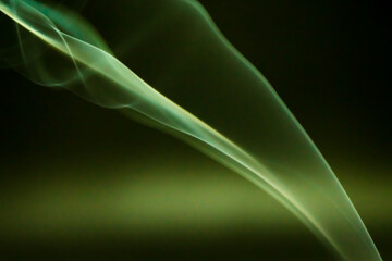 Naklejka premium Smoke scented candles on a black background