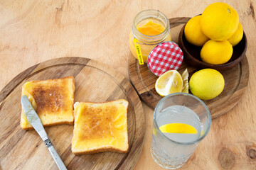 Lemon butter on two pieces of toast with lemon water