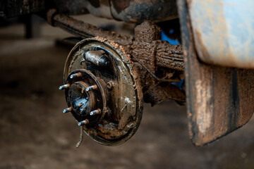 Old rusty brake system in the car with mud.