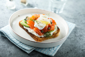 Poached egg with salmon and avocado on toast