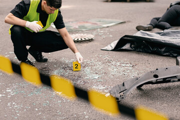 Close-up of policeman doing investigetion at road accident area