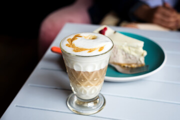 Glass of Latte macchiato with rich milk foam in cafe