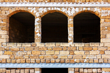 Windows and walls of an unfinished abandoned house
