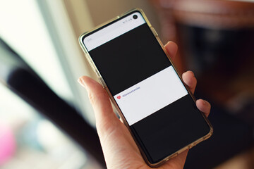 White hand holding a cellphone with black squares in Social Media Feed. Blackout Tuesday happened on Tuesday, June 2nd in solidarity of victims of racism in the US.