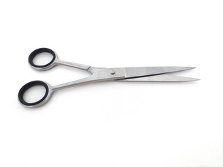 Aerial view of semi open scissors for haircut, beard, stainless steel. Cutting shears horizontally isolated on white background. Haircut accessories.