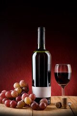 Wine bottle with wine glass and grape.