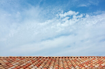 Naklejka premium red roof tiles on blue sky