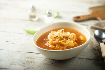Traditional homemade sauerkraut soup in a white bowl