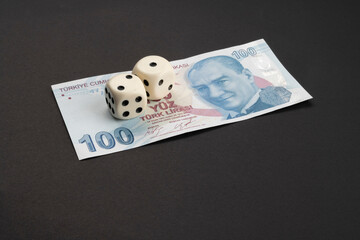 Money, finance and gambling concept: On top of frame 100 (hundred) Turkish TL, lira banknote with...
