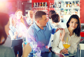 Man trying to seduce female colleague