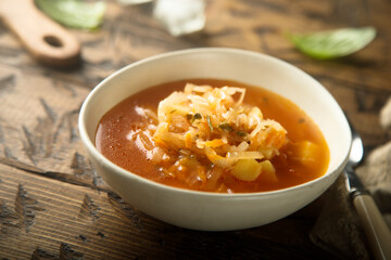 Traditional homemade sauerkraut soup in a white bowl
