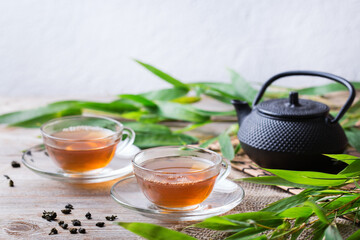 Cup of hot green tea on a wooden table