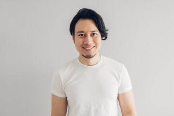 Happy smile face Asian man with long black hair and white t-shirt.