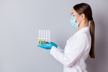 Profile photo of virologist doc lady experienced professional hold test tubes examining vaccine probes wear gloves facial mask protective glasses uniform lab coat isolated grey background