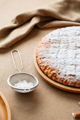 Closeup on sweet pie sprinkled with powdered sugar
