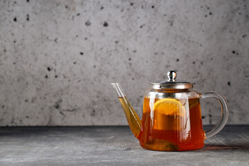 Hot healthy black tea with lemon in glass teapot 