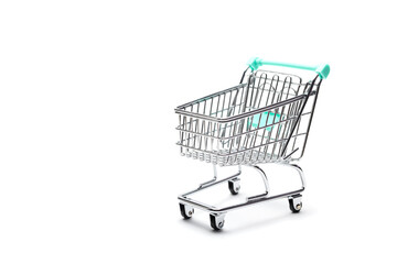 Miniature empty shopping cart on colorful background