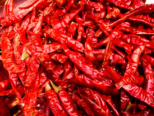 Dried red hot chili on wooden plate, Food ingredient for spicy recipe.