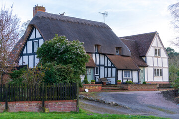 Fototapeta na wymiar Traditional cottage houses with the straw roof Aspley Guise, Milton Keynes