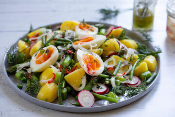 Summer salad with potatoes, green beans, asparagus, peas and radishes