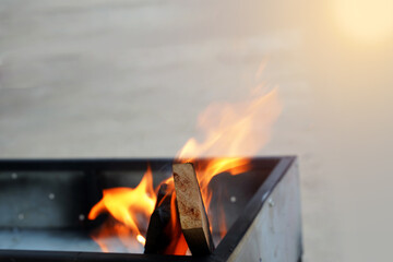 The fire is burning wood on the stove.