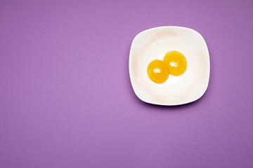 Cracked egg on purple background